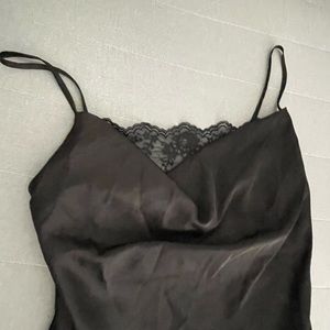 Black long slip dress with a lace neckline and a slit